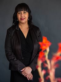 A person in a black suitAI-generated content may be incorrect.