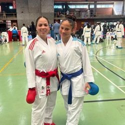 Two women in karate uniformsDescription automatically generated