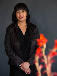 A person in a black suitAI-generated content may be incorrect.